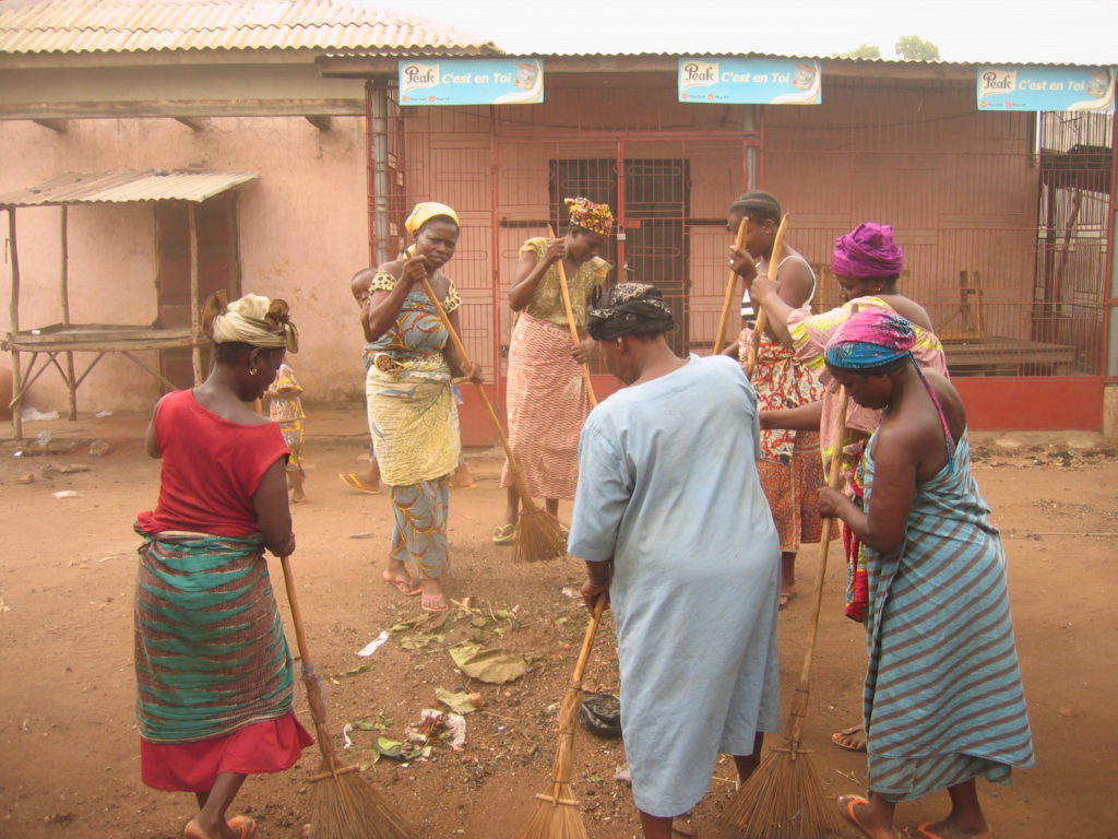 un groupe de femme balaye dans une ville au Bénin